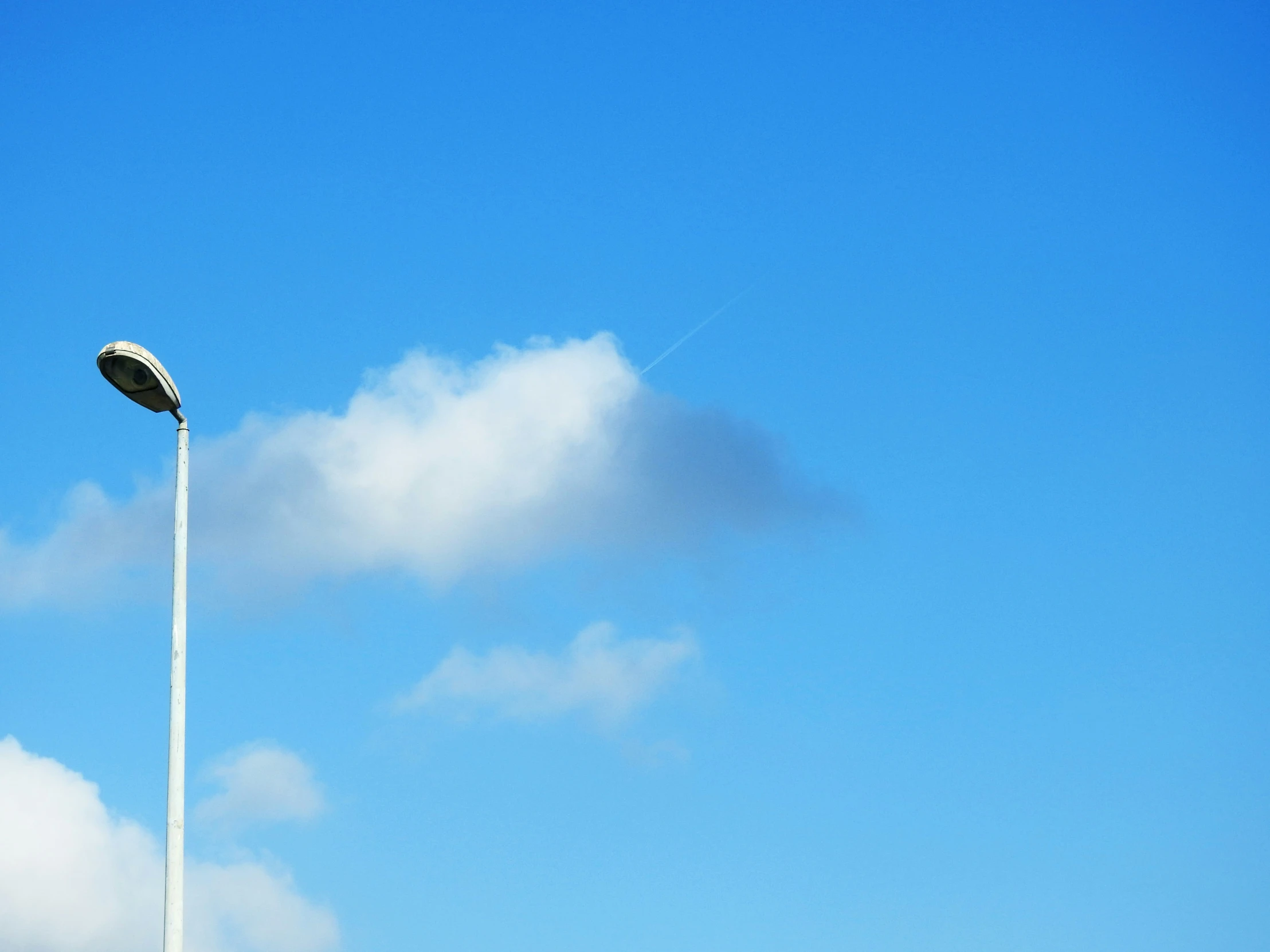 a street light with a blue sky behind it