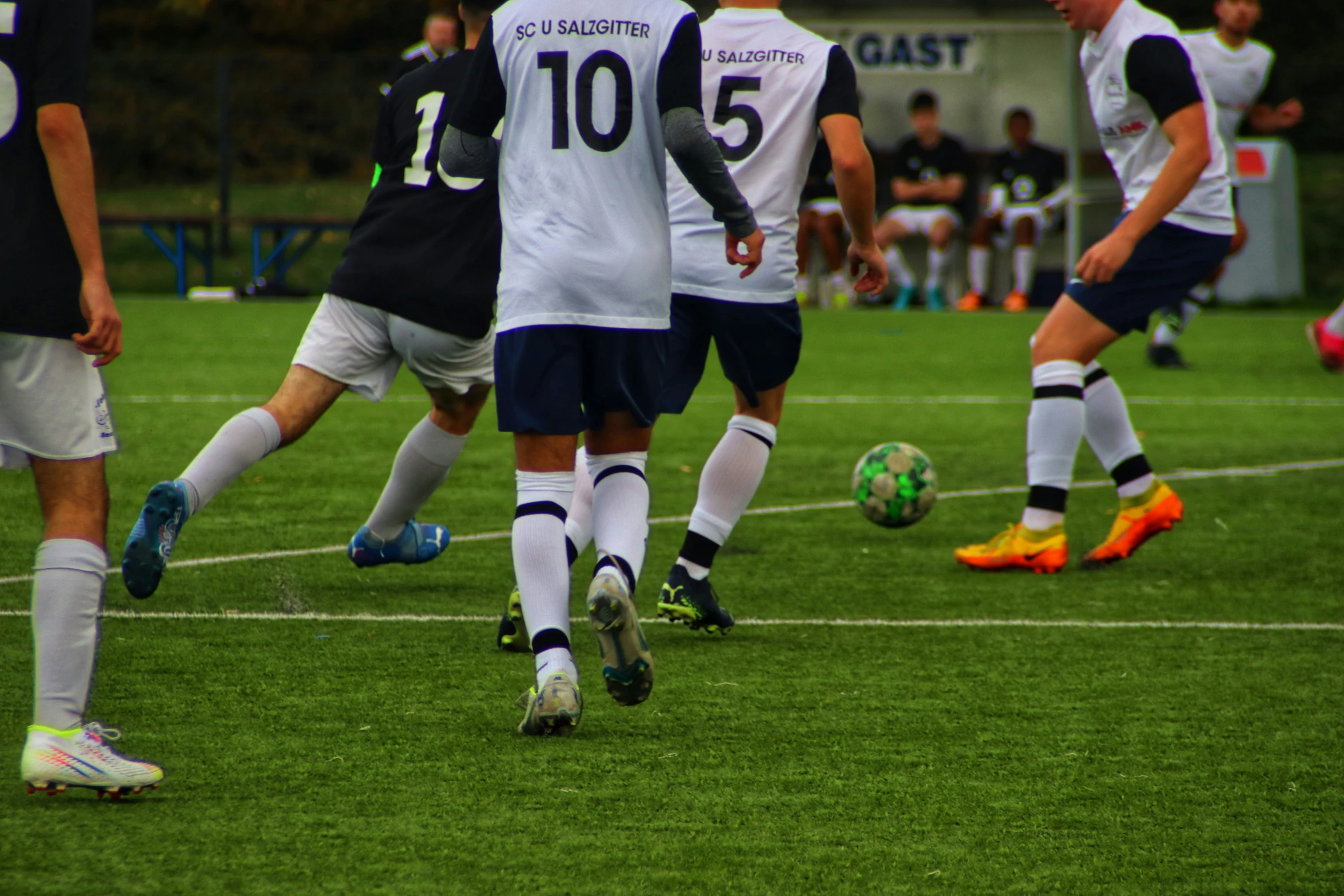 a soccer team going after the ball while on the field