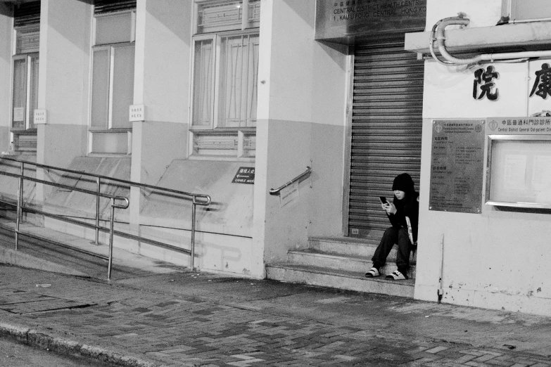 a woman walking down the street holding a cell phone