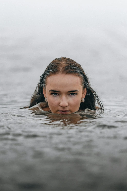 girl in water with one eye on open head