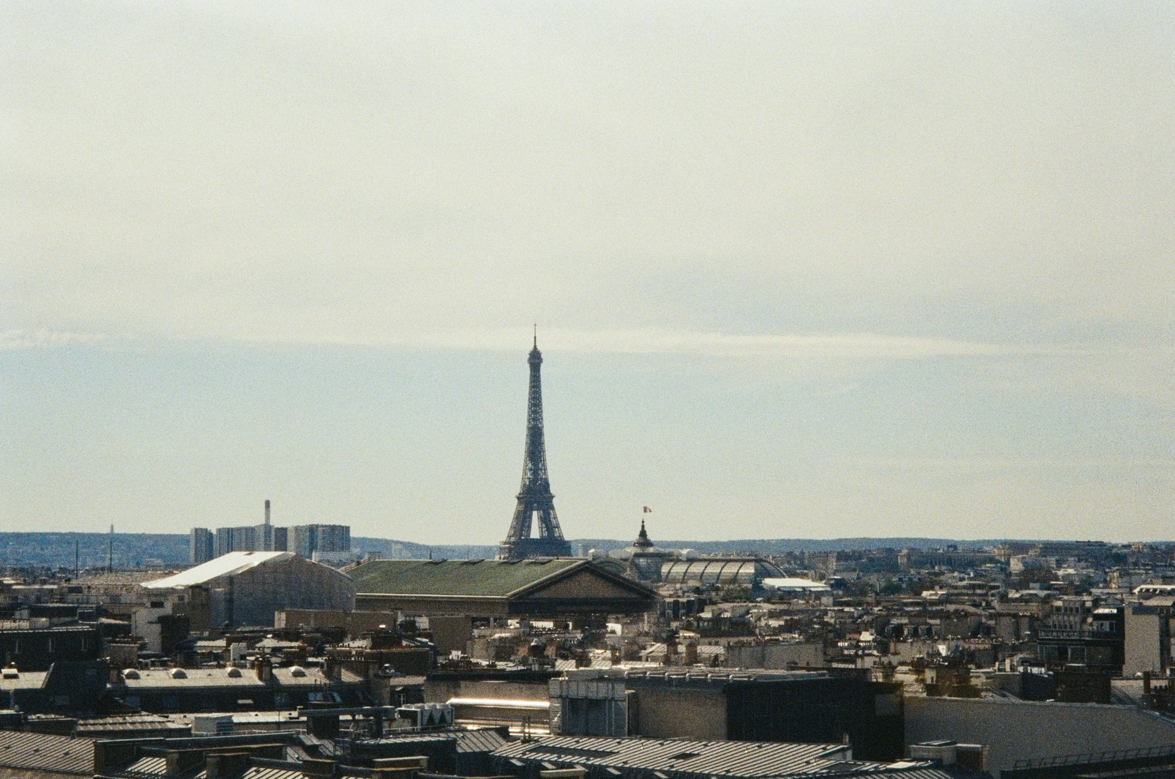 a large city that has a very tall tower in the background