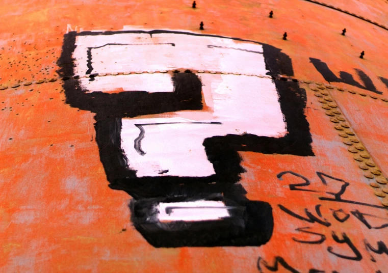 the number five is painted on the side of an orange pipe