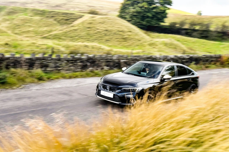 black car moving on country side in daylight