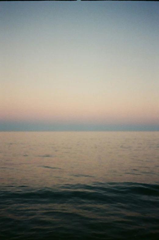 two distant boats on the water and a sky