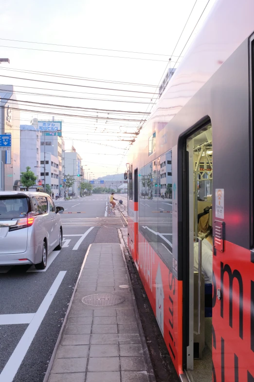 a silver train is traveling down the tracks next to another car