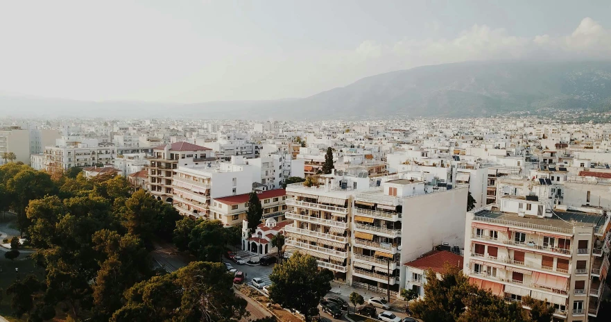 a city is shown with some buildings and trees in the foreground