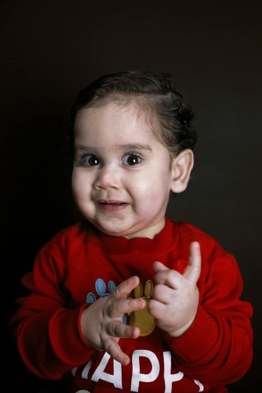 an infant girl poses for a po with some cookies