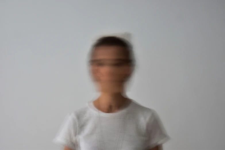 an blurry image of a young woman standing