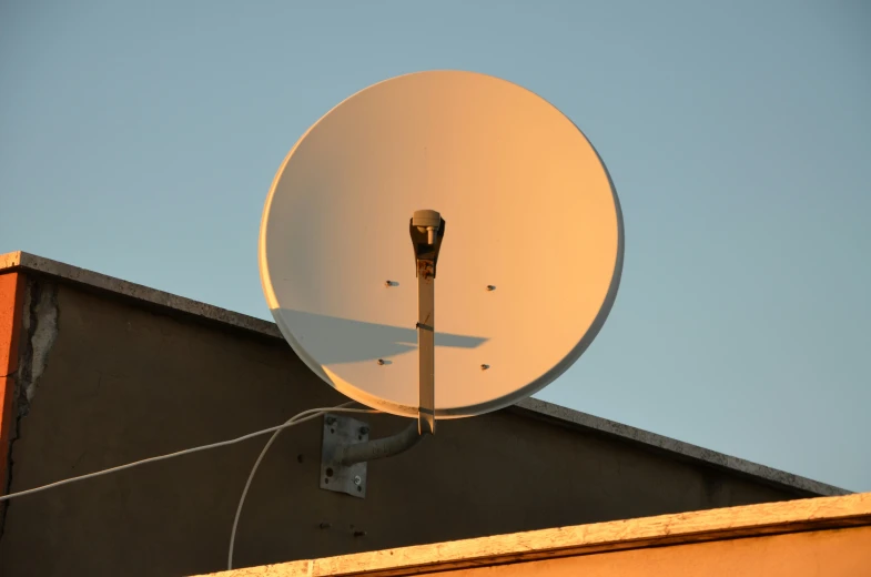 a very tall white satellite dish on top of a building