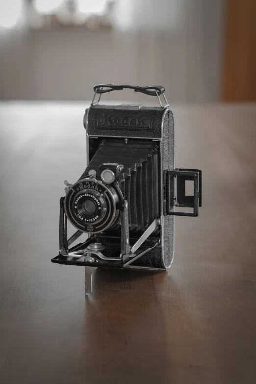 a small model camera sitting on a wooden table