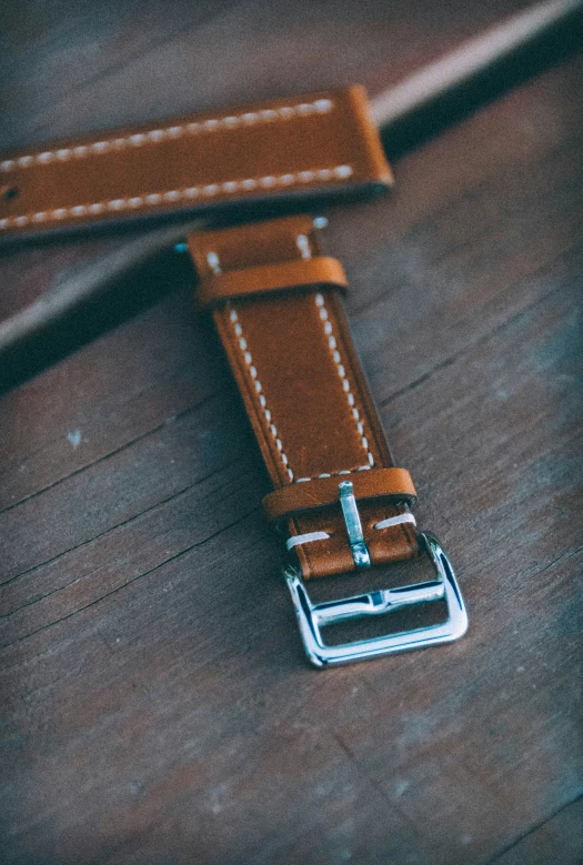 brown strap sitting on the back of a brown watch