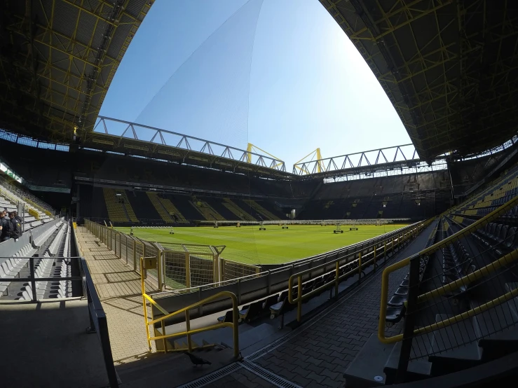 a stadium filled with lots of fans and a green field