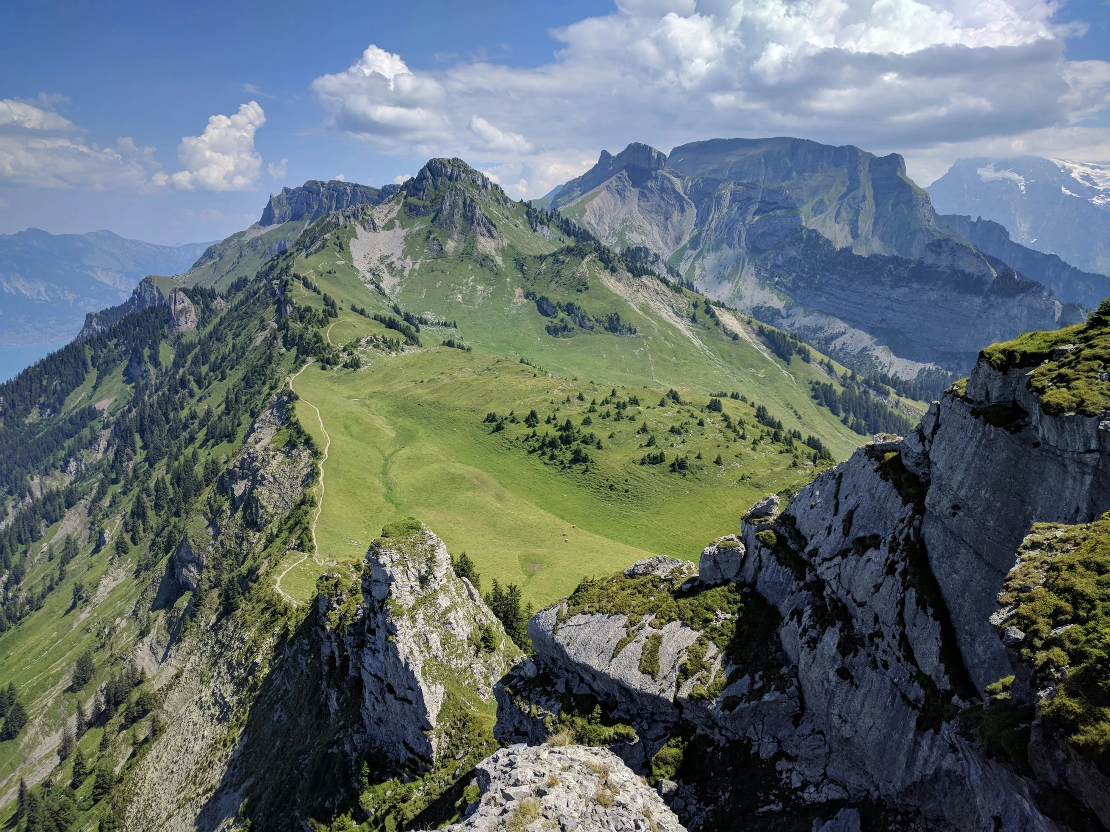 mountains covered in grass and a sky filled with clouds