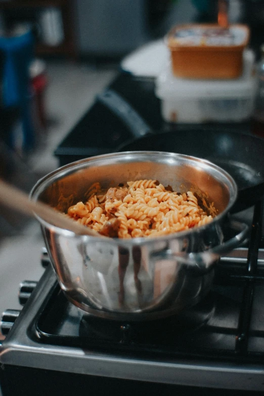 some food that is cooking in a pot on top of the stove