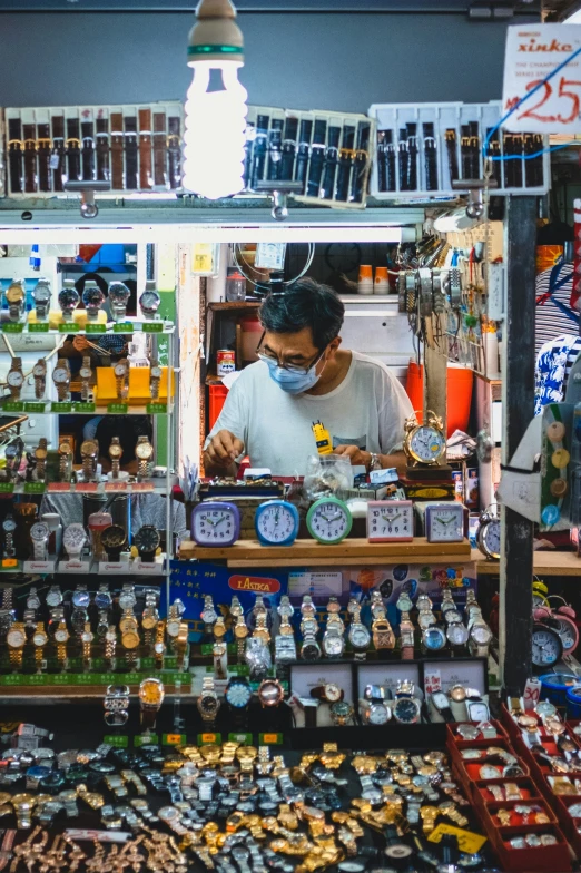 a man is standing by a table full of things