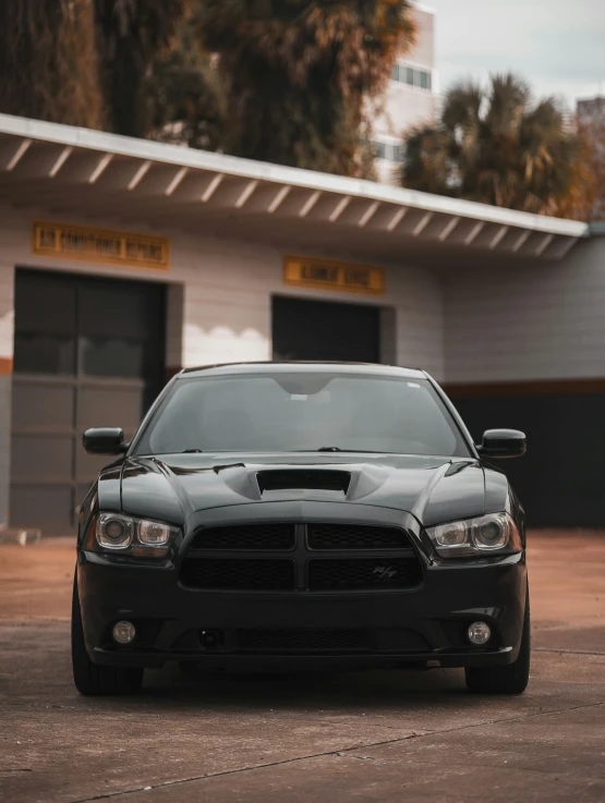 a dodge car is parked in front of a building