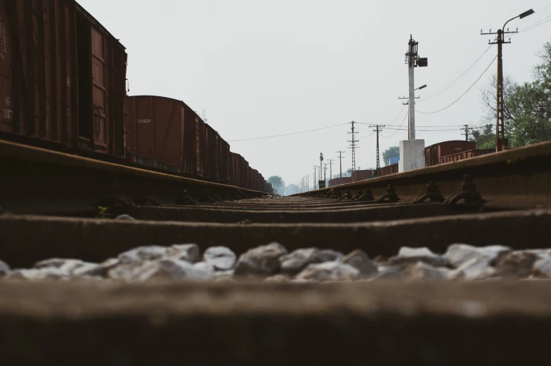 railroad tracks near a bridge and power poles