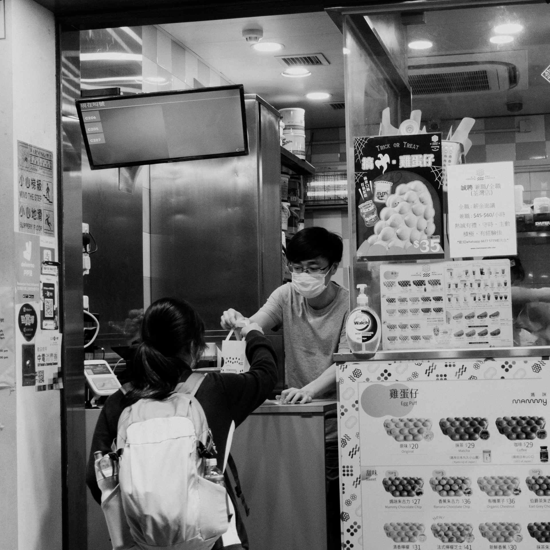 a couple of people in a restaurant near signs