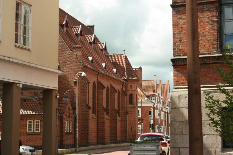 a large long brick street next to tall buildings