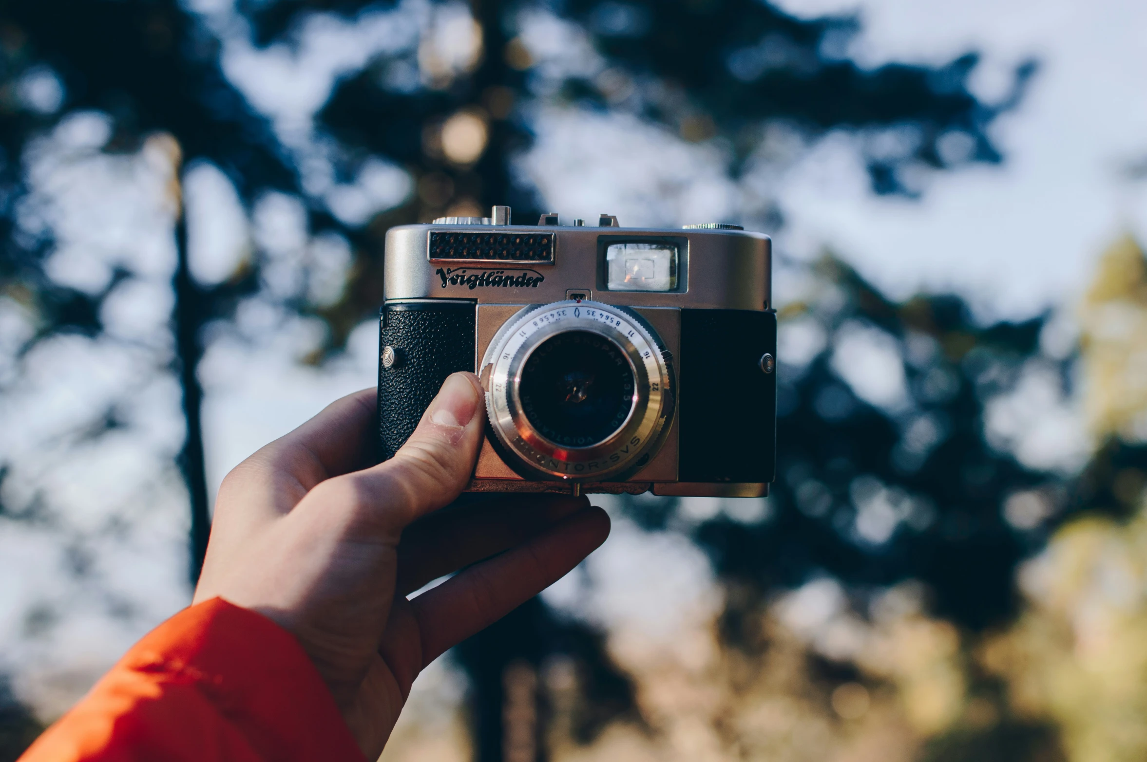 a person holding a camera to take pictures