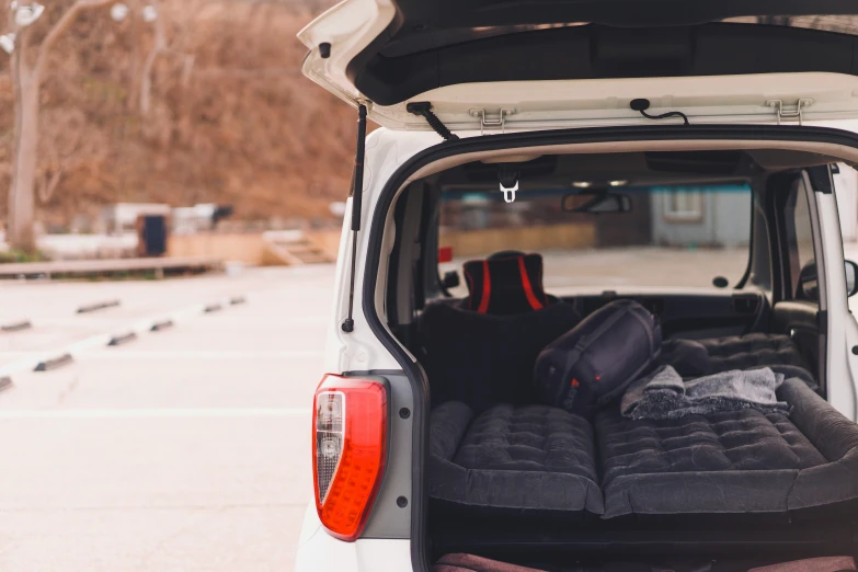 an opened trunk and back seat in the back of a truck