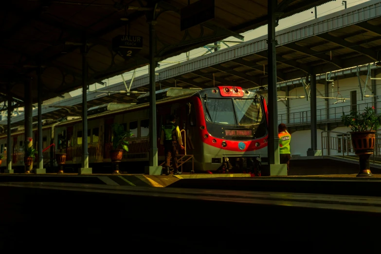 the train is parked under the bridge on its tracks