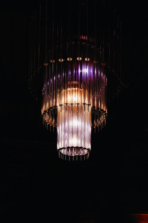 the chandelier lit up in the dark is an eye - catching idea