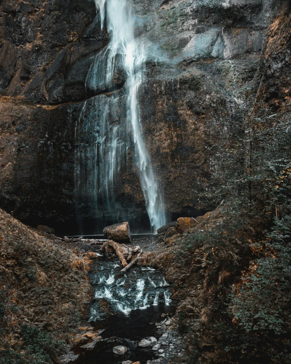 a waterfall that is on top of a cliff