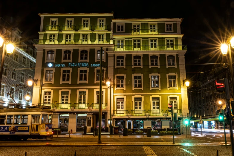 night time street scene with yellow passenger buses and buildings