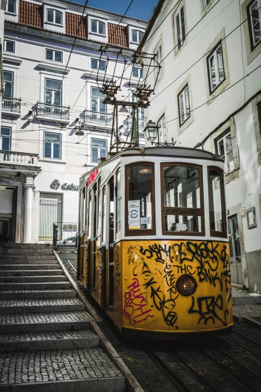 a trolley car is on tracks near some buildings