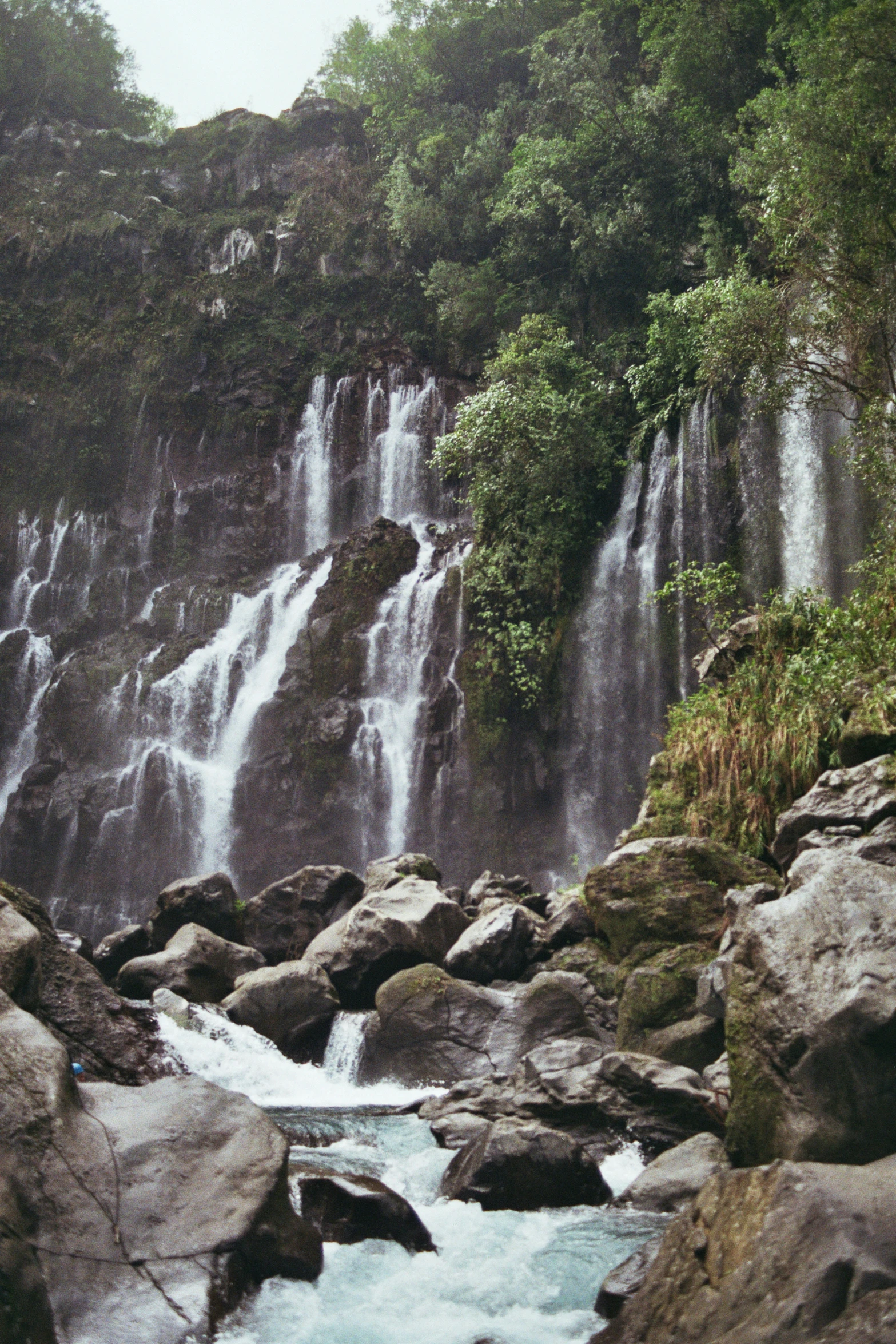 a waterfall with a few rocks near by