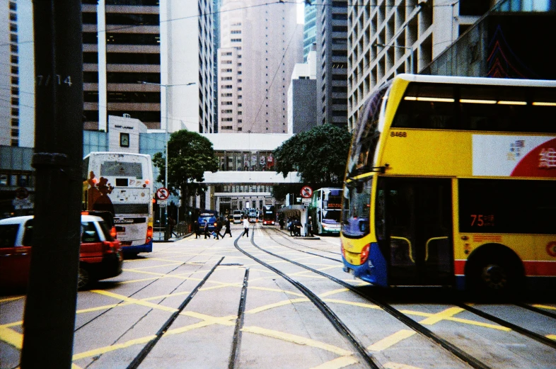 buses and pedestrians walking in a busy city