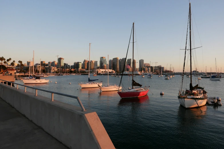 boats floating on top of a lake in front of a city