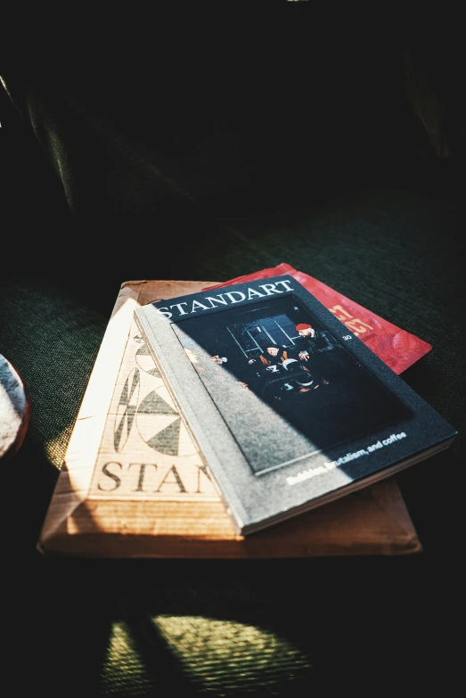 a variety of books and a teapot on a wooden tray