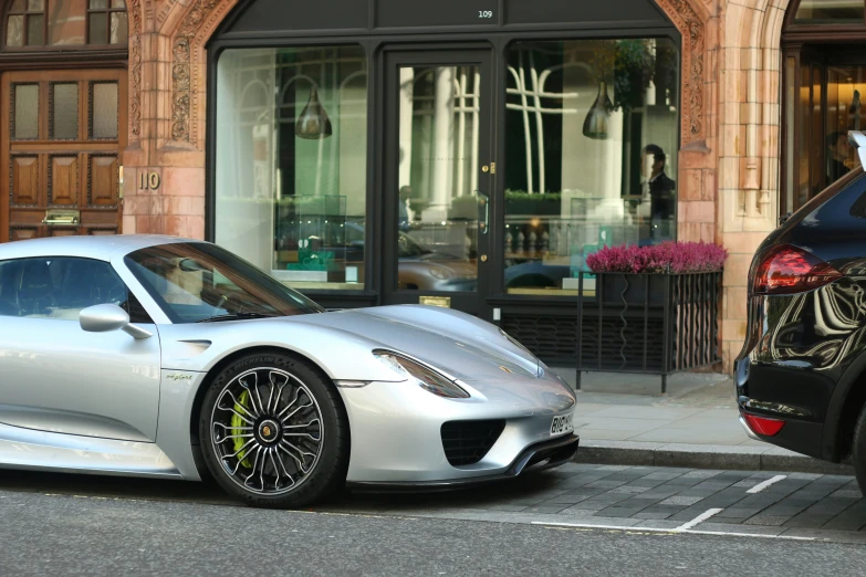 two sport cars parked near one another outside a restaurant