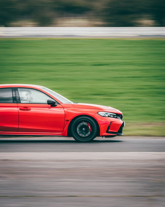 the red bmw car drives on a race track