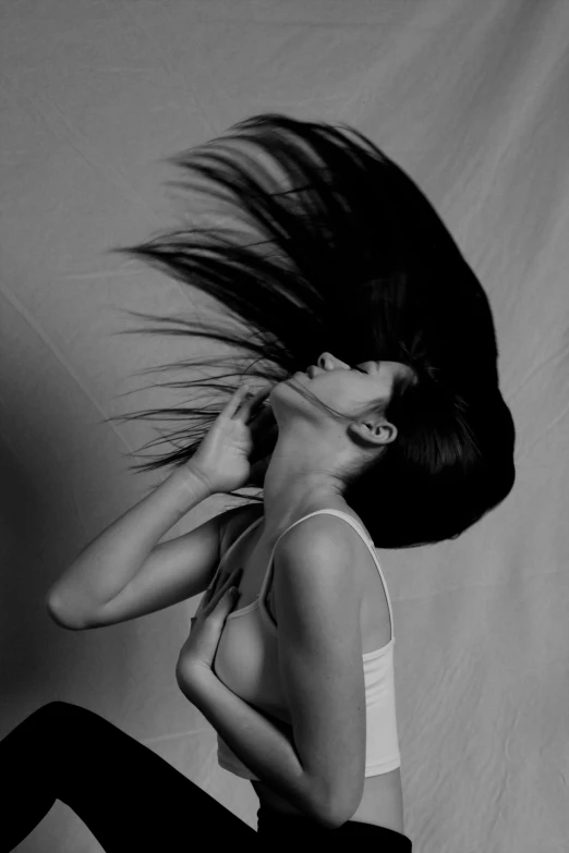 a woman with her hair up while sitting on a bed