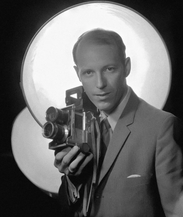 an old black and white po of a man holding a camera