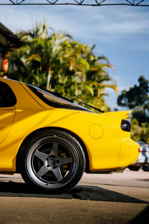 there is a yellow sports car parked on the road