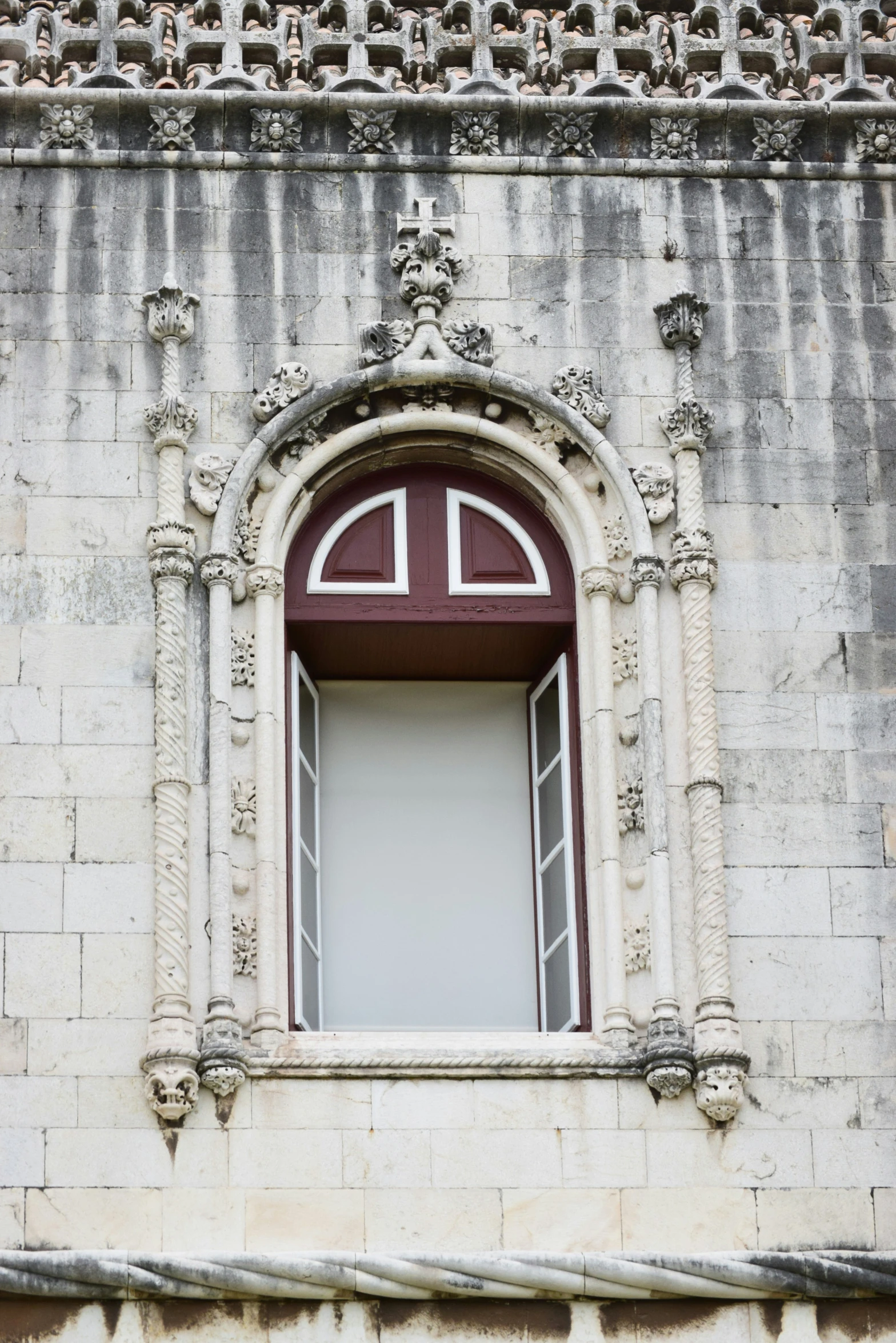 a stone building with an old window and door