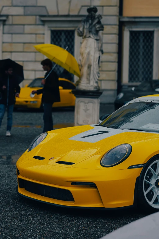 this yellow car has two white stripes on it