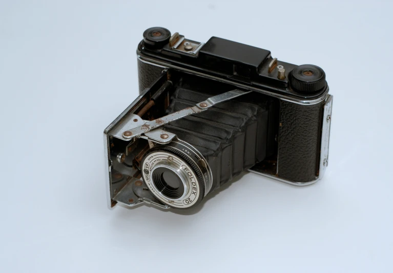 an old fashioned camera is sitting on a white background