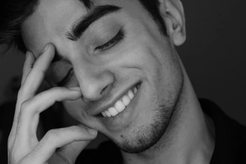 a man smiles while posing for the camera