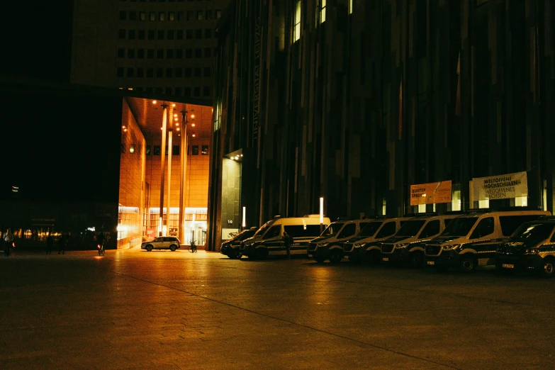 a night view of many parked cars on the street