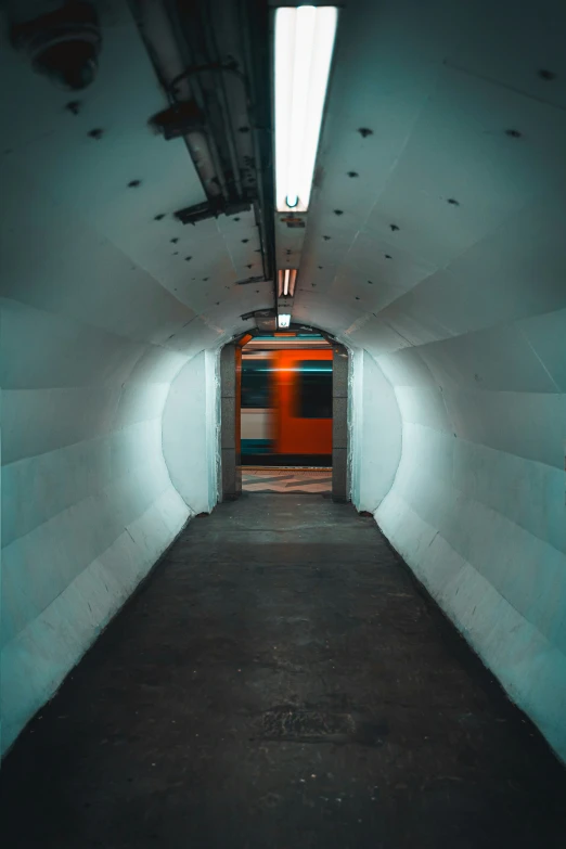 an indoor tunnel with a light at the end