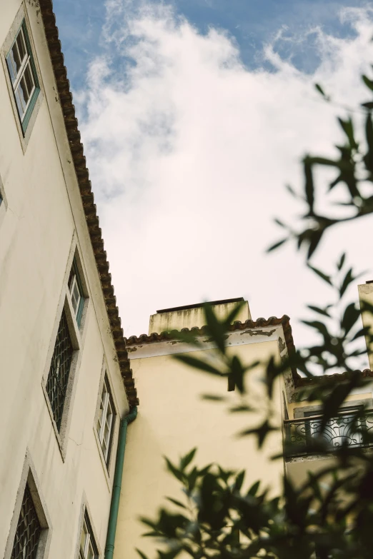 a tall building under a cloudy blue sky