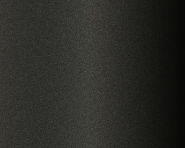 a large black dot pattern on the surface of a dark background