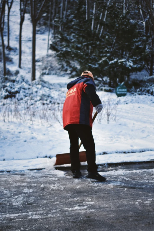 a man standing in the snow near some trees