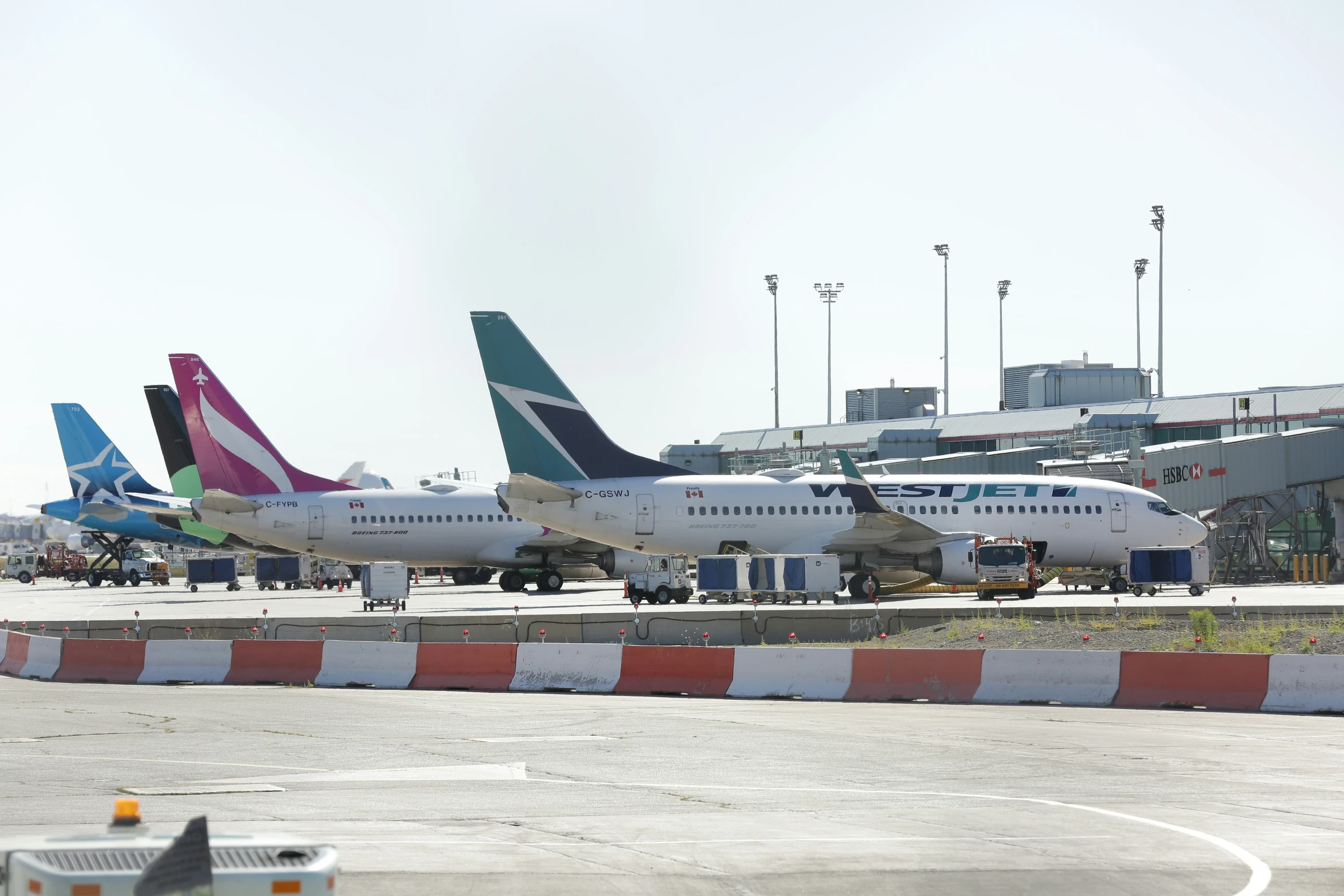 some planes are parked at the airport with a traffic light