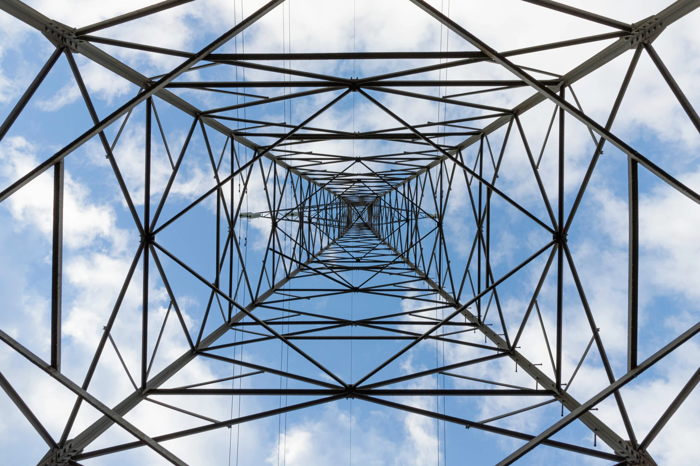 a large structure with lots of power lines going across it